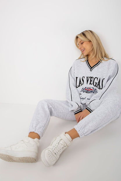 A casual set featuring a long-sleeve sweatshirt with a heart-shaped neckline, paired with long pants with a waist tie and slip pockets, offering comfort and style with a Las Vegas-inspired design.