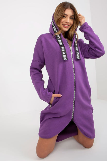 A women's sweatshirt with an extended cut, long sleeves, and a hood. Features a zip-up front and zippered slip pockets on the sides for added functionality.






