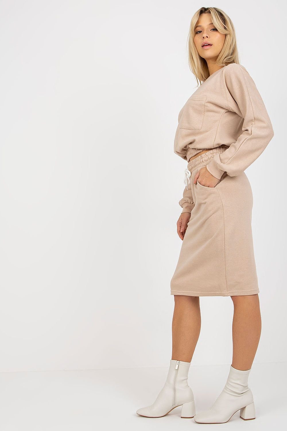 A complete tracksuit set featuring a long-sleeve sweatshirt with a round neckline and a skirt with a waist tie and slip pockets for convenience.






