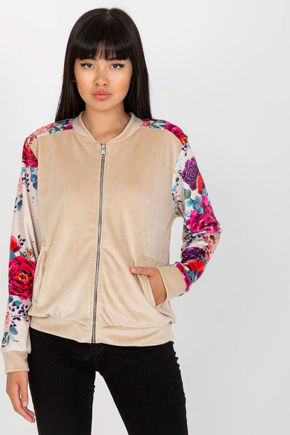 A stylish velour bomber jacket featuring a zipper closure, side slip pockets, and long sleeves adorned with colorful floral fabric. A perfect blend of elegance and casual charm.






