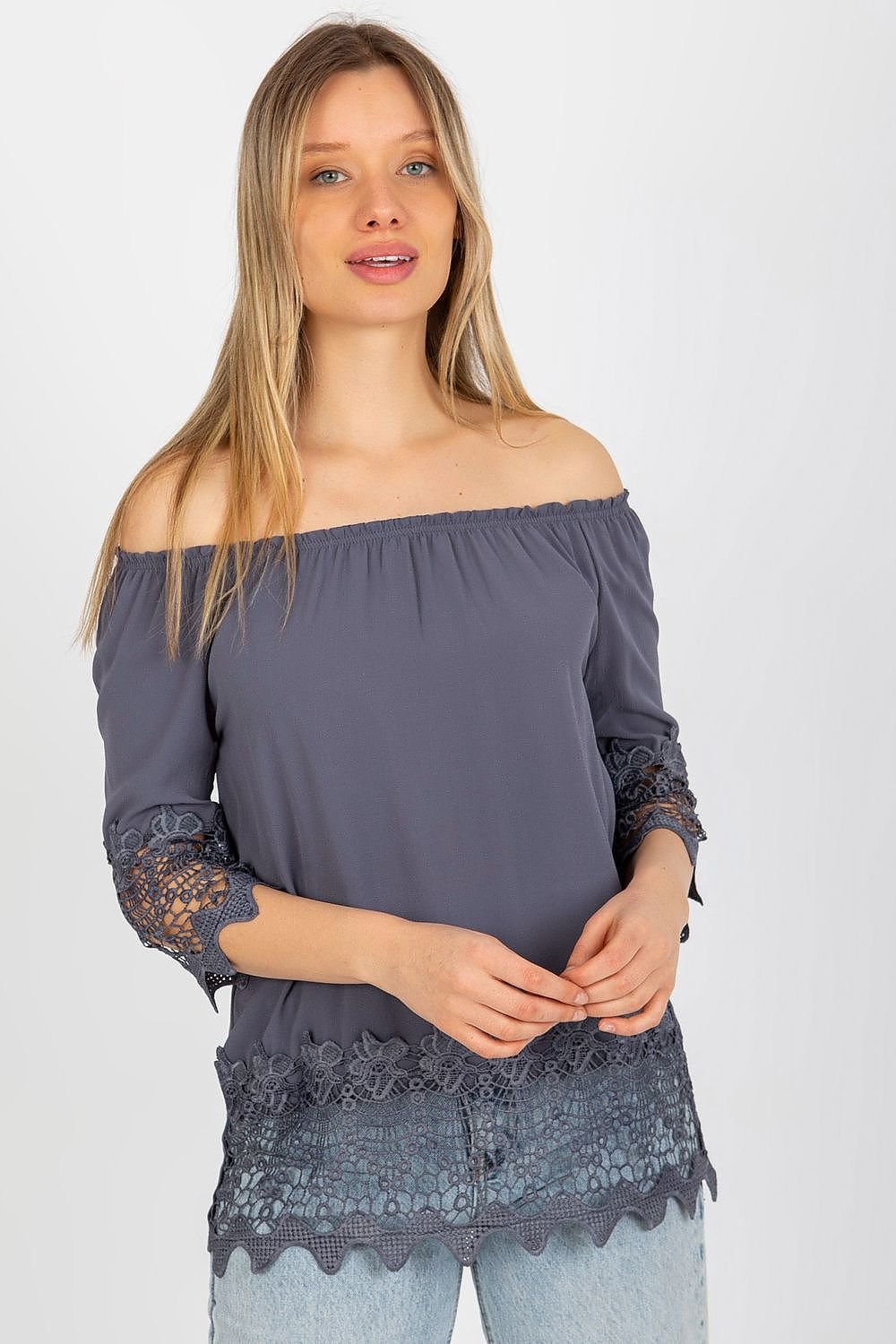 Elegant blouse with 3/4 sleeves, Spanish-style neckline, and decorative trim at the sleeves and bottom for a unique touch.