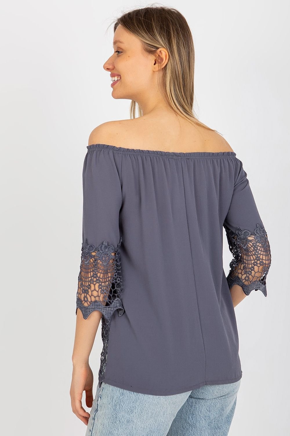 Elegant blouse with 3/4 sleeves, Spanish-style neckline, and decorative trim at the sleeves and bottom for a unique touch.