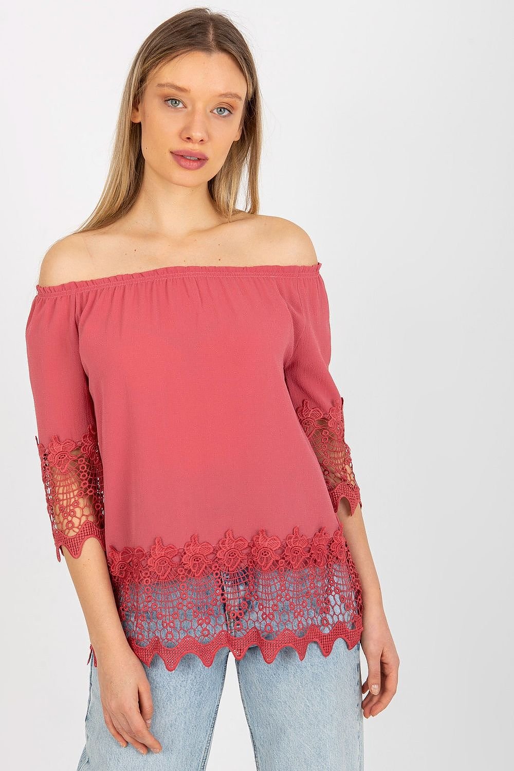 Elegant blouse with 3/4 sleeves, Spanish-style neckline, and decorative trim at the sleeves and bottom for a unique touch.