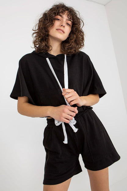 Comfortable  black tracksuit set featuring a hooded blouse with short wide sleeves and a kangaroo pocket, paired with shorts that have a waist tie and slip pockets. Ideal for casual wear.