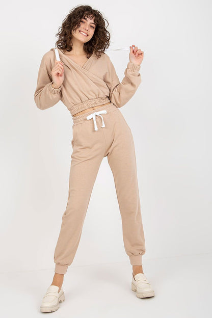 A short sweatshirt with long sleeves, a hood, and an envelope neckline, paired with long pants featuring a waist tie and slip pockets, offering comfort and a relaxed fit.