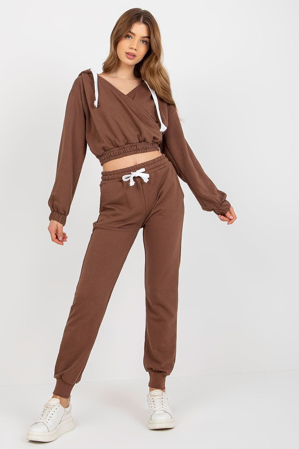 A short sweatshirt with long sleeves, a hood, and an envelope neckline, paired with long pants featuring a waist tie and slip pockets, offering comfort and a relaxed fit.