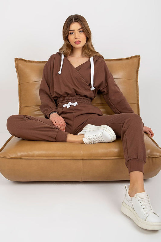 A short sweatshirt with long sleeves, a hood, and an envelope neckline, paired with long pants featuring a waist tie and slip pockets, offering comfort and a relaxed fit.