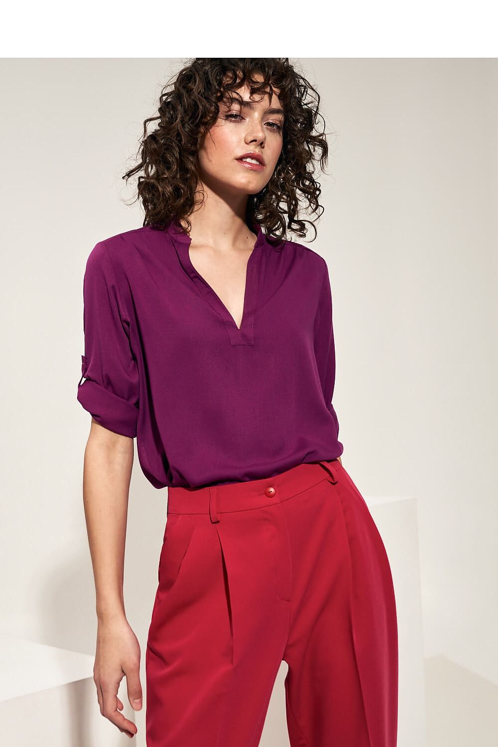 A premium viscose blouse featuring a unique crease at the neckline, rolled-up sleeves, and a relaxed fit. Perfect for polished office looks, pairs well with high-waisted black pants and pencil skirts.