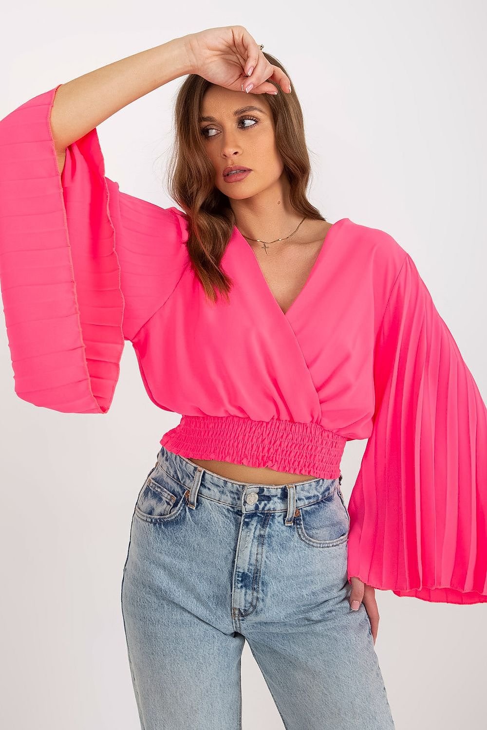 Elegant blouse featuring an envelope neckline, pleated wide sleeves, and supportive elastic at the bottom for a flattering fit.