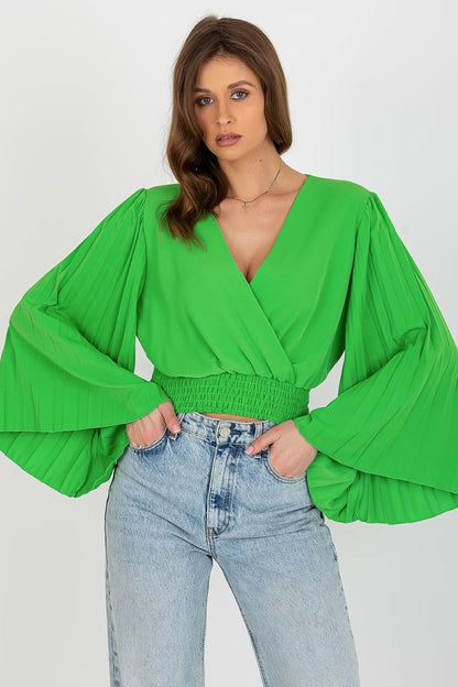 Elegant blouse featuring an envelope neckline, pleated wide sleeves, and supportive elastic at the bottom for a flattering fit.