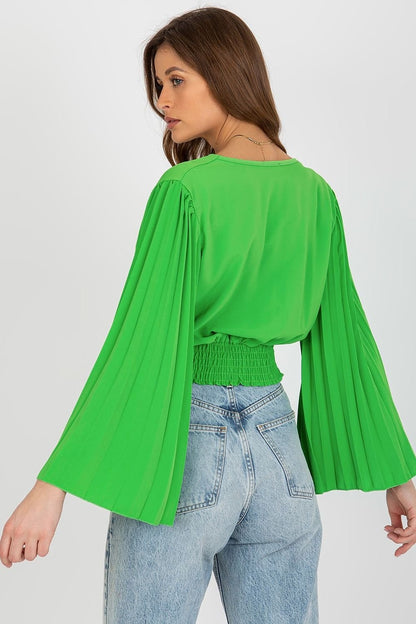 Elegant blouse featuring an envelope neckline, pleated wide sleeves, and supportive elastic at the bottom for a flattering fit.