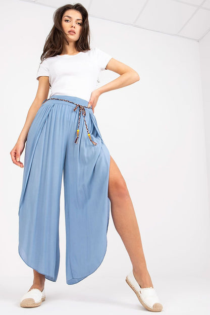 Boho-style seam pants made from smooth material with a high waist that accentuates the figure. Featuring wide legs with slits for freedom of movement, a waist tie for a perfect fit, and a minimalist design without pockets, these pants offer comfort and elegance for casual and everyday wear.

