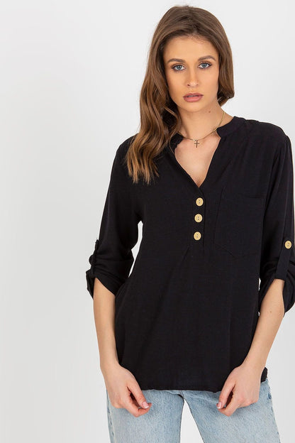 A shirt-like blouse with long sleeves, a heart-shaped neckline, and a decorative front clasp and pocket. Features sleeves with the option to roll up. Perfect for a variety of occasions.