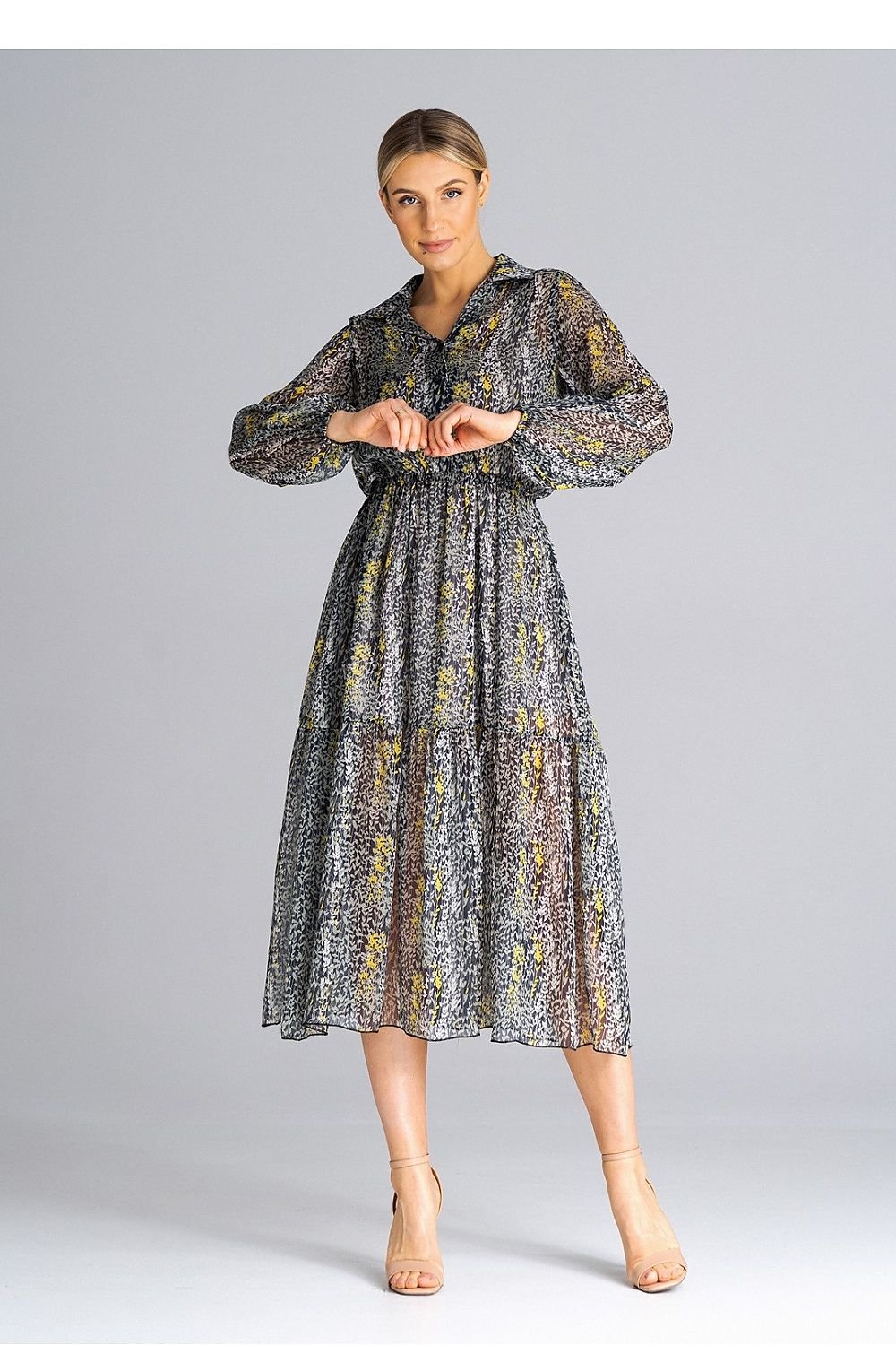 A midi-length, flared, lined dress with long crinkled sleeves with elastic, a collared neckline, a button-down waist, and a wide ruffle at the bottom for a feminine touch.






