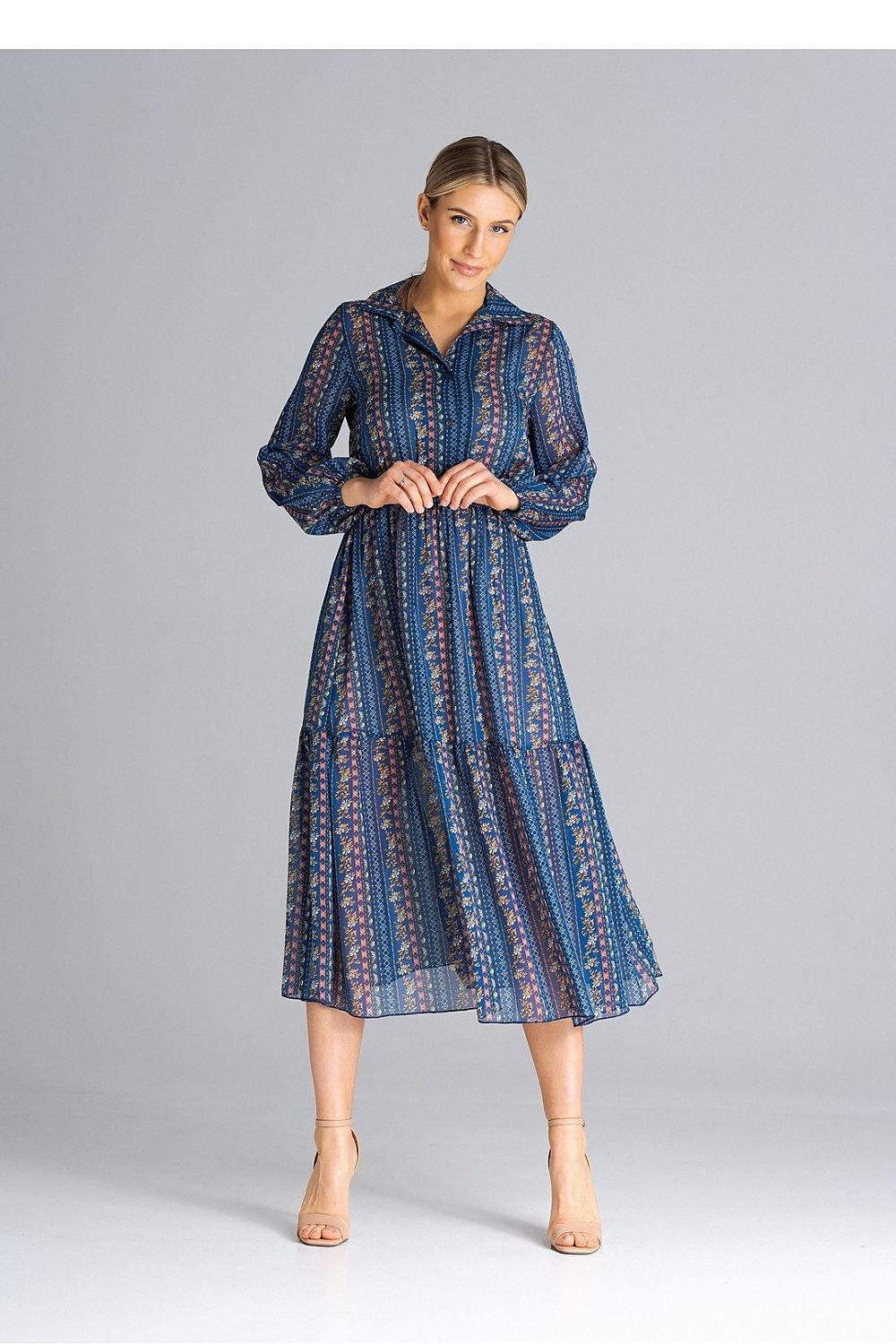 A midi-length, flared, lined dress with long crinkled sleeves with elastic, a collared neckline, a button-down waist, and a wide ruffle at the bottom for a feminine touch.






