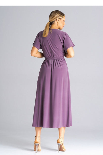 A stylish dress featuring an overlapping neckline, short draped sleeves, an elastic waistband, and asymmetrical side slits for added elegance.






