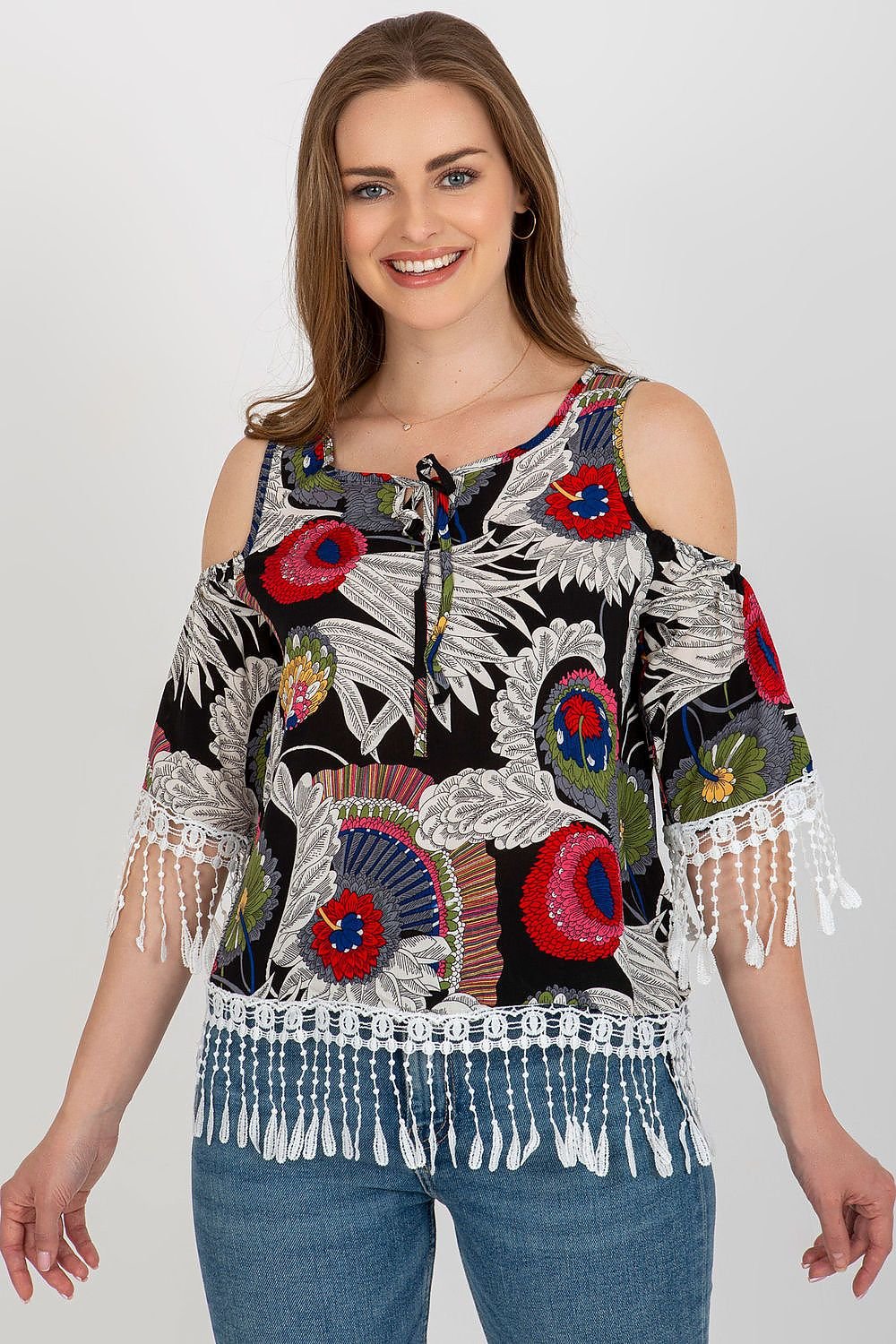 Stylish summer blouse in printed fabric with 3/4 sleeves, round neckline, and decorative tassels with a tie closure.