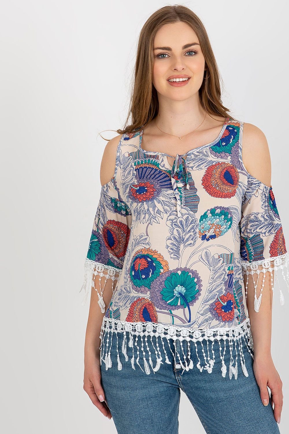 Stylish summer blouse in printed fabric with 3/4 sleeves, round neckline, and decorative tassels with a tie closure.