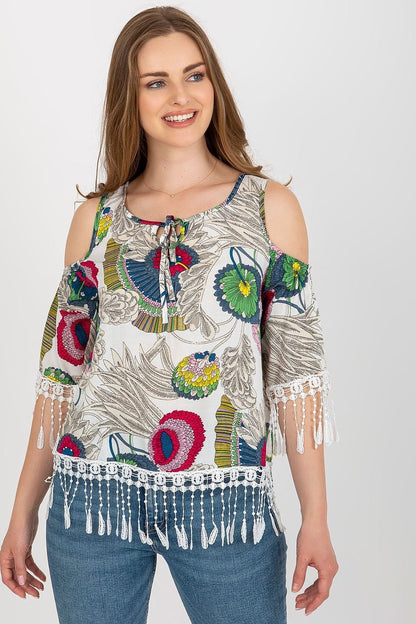 Stylish summer blouse in printed fabric with 3/4 sleeves, round neckline, and decorative tassels with a tie closure.