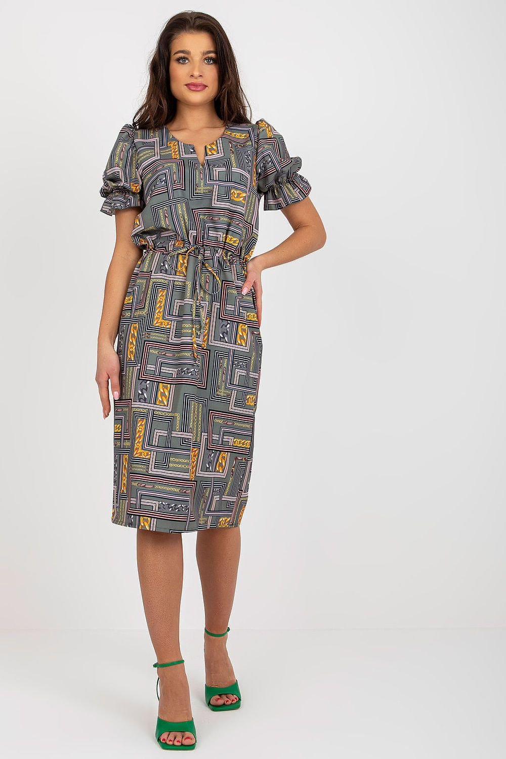 A chic dress featuring short sleeves with buffet-style cuffs and a decorative slit neckline. Tied at the waist for a flattering silhouette, this dress combines elegance and modern design for a stylish look.






