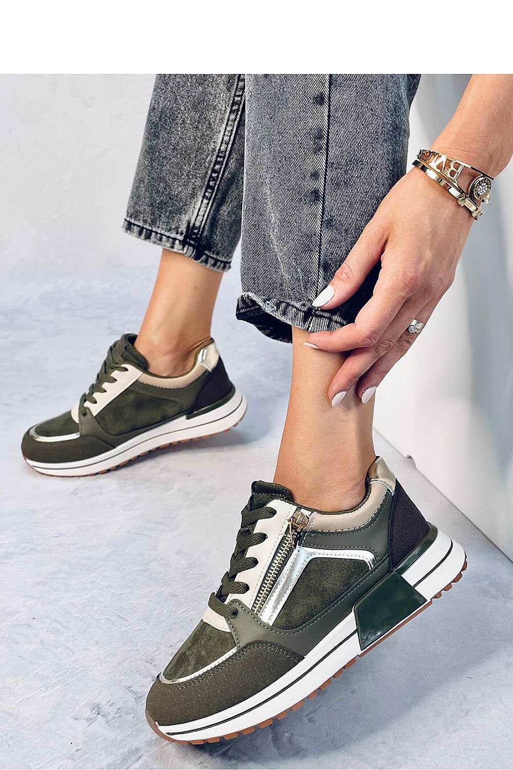 Chic women's lace-up sports sneakers featuring metallic and gold accessories, blending glamour with a classic design. Made from ecological leather and suede with a fabric-lined interior, these sneakers are perfect for both sporty and casual outfits. A stylish addition to your closet.






