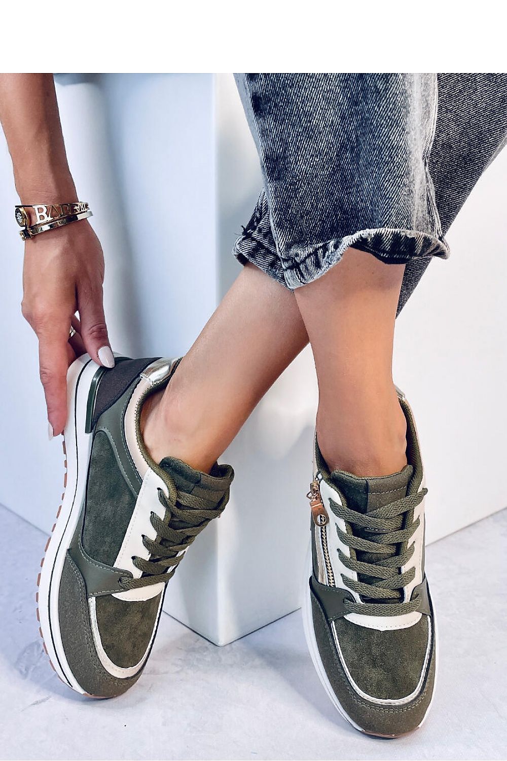 Chic women's lace-up sports sneakers featuring metallic and gold accessories, blending glamour with a classic design. Made from ecological leather and suede with a fabric-lined interior, these sneakers are perfect for both sporty and casual outfits. A stylish addition to your closet.






