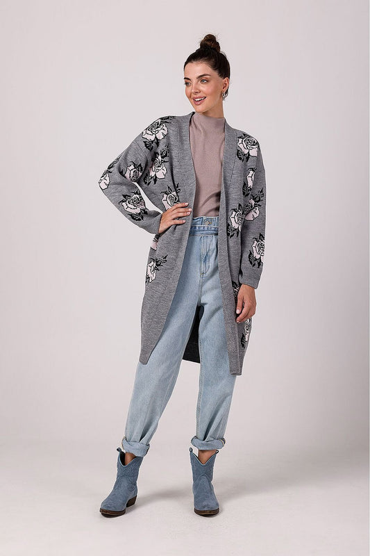 A soft, long floral cardigan featuring a charming rose motif, no fastening, and a relaxed fit with lowered shoulder lines and long, loose sleeves. Perfect for both work and casual outings, this cardigan offers exceptional comfort and style, made in Poland.